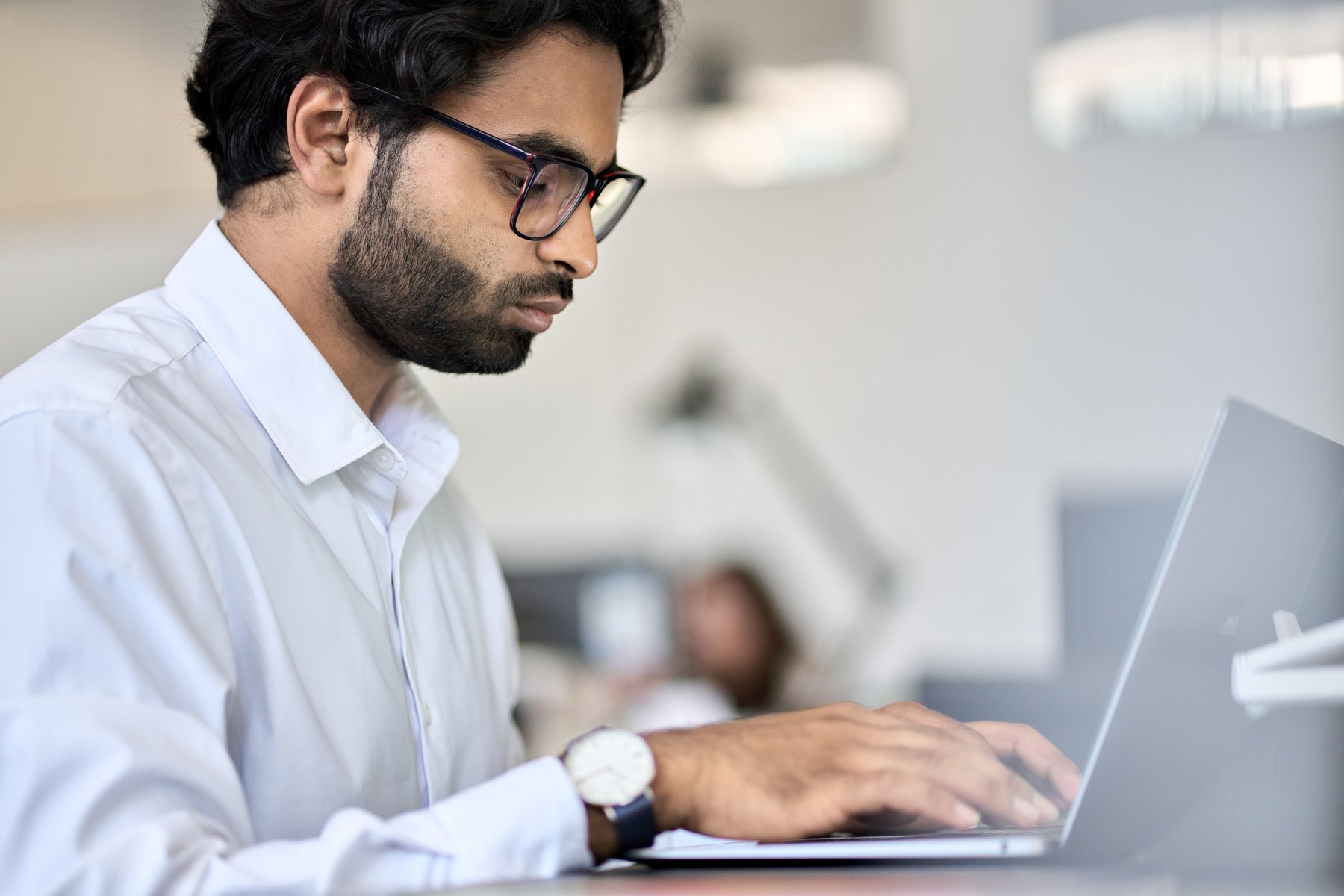 software engineer using laptop computer working in office.